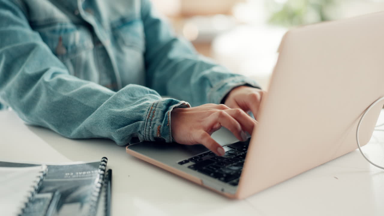 Woman Typing on Laptop Wearing Jean Jacket