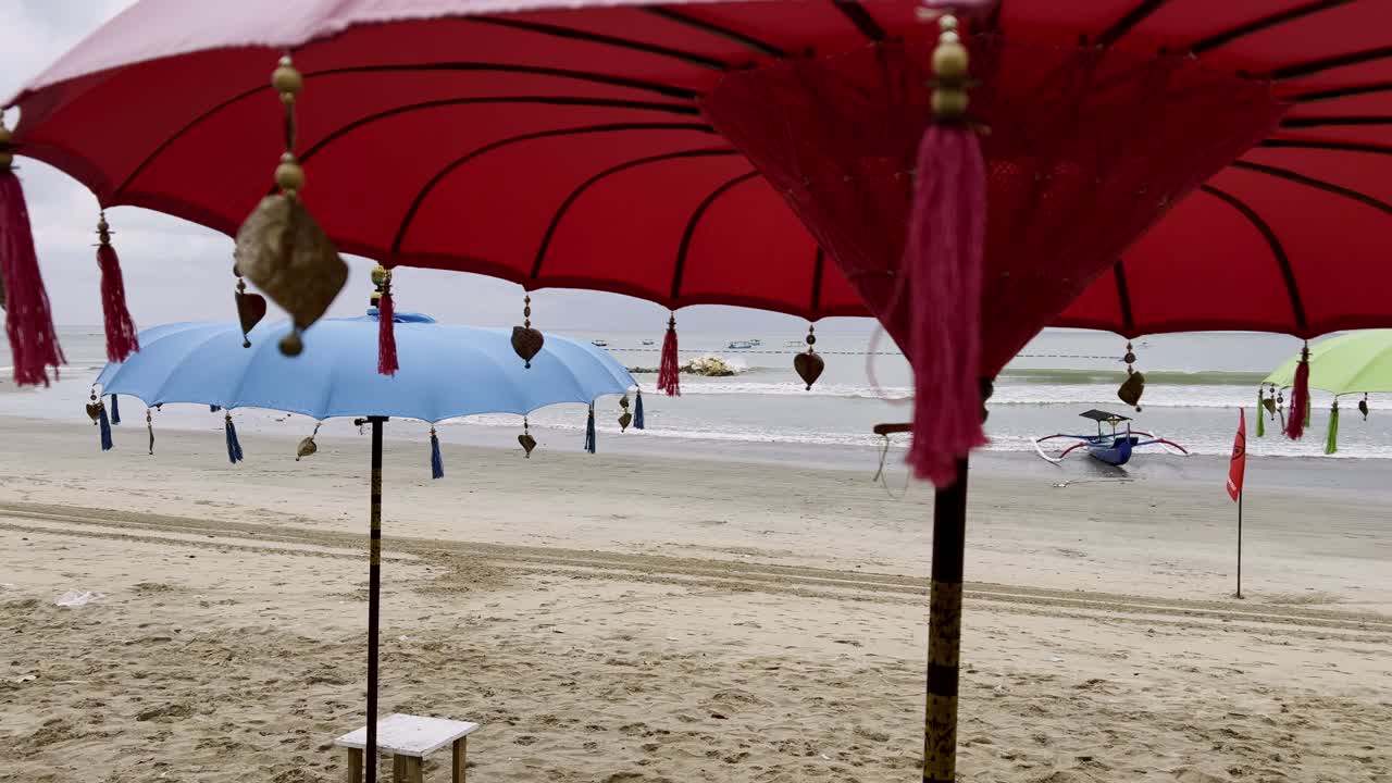Kuta Beach Bali showcases island charm with golden sand, Balinese umbrellas, fishing boats, and rolling surf, a perfect tropical destination for travelers and adventurers