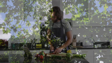chopping vegetables in kitchen, man with animated leaves overlay in background