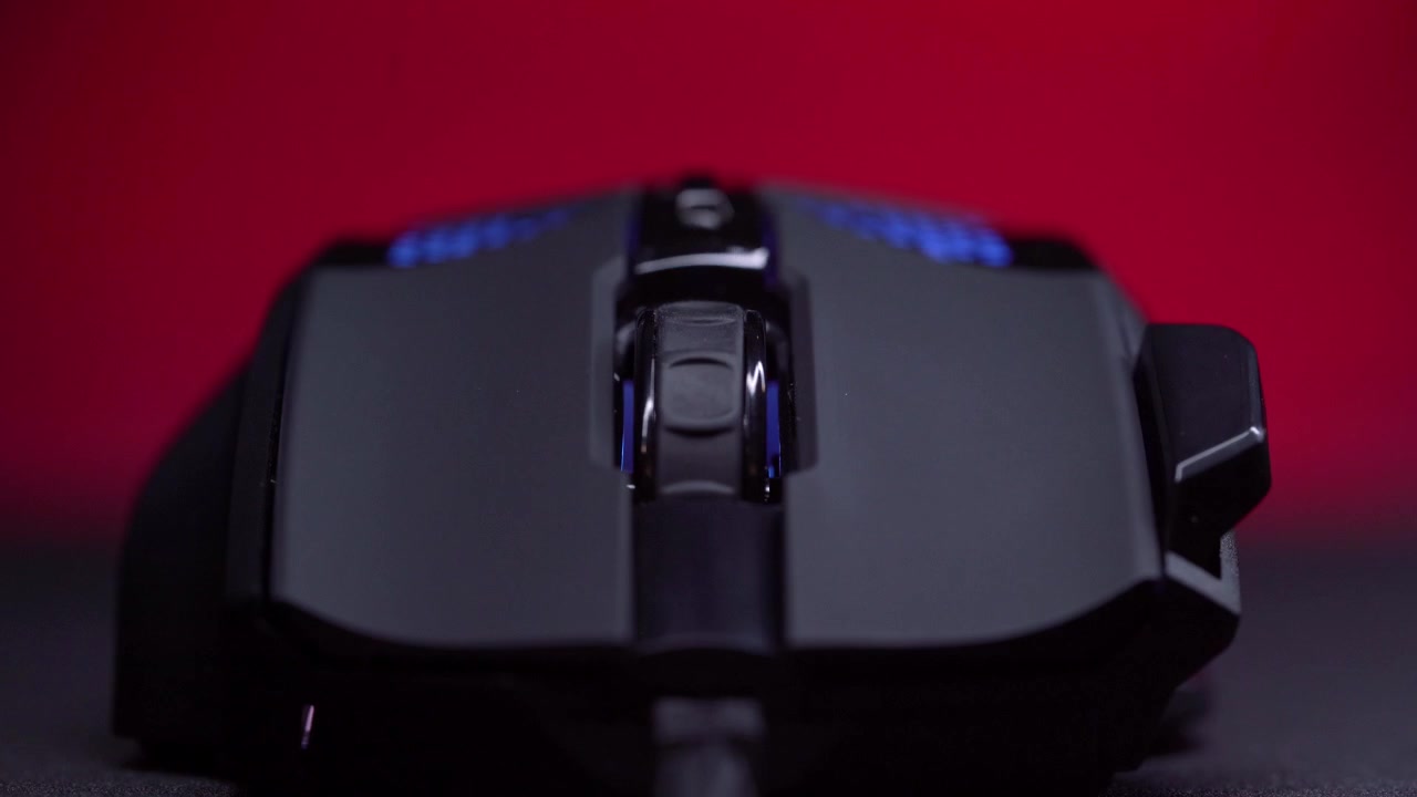 Black Gaming Mouse with Dynamic RGB LED Lights on Red Background