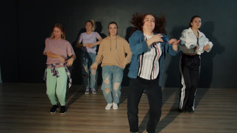 group of young women dancing hip-hop style in a dance studio