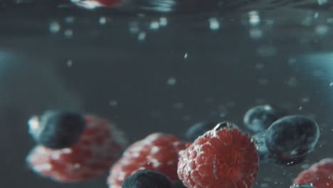 berries landing into water in slow motion