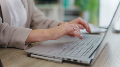 woman writing on laptop