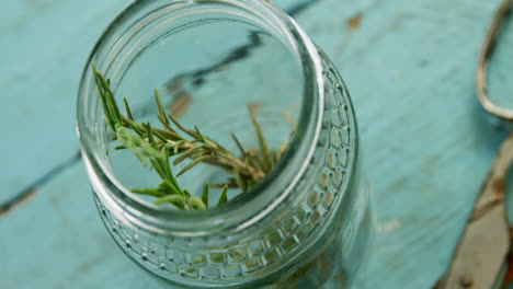 Rosemary-and-scissors-on-wooden-table-4k