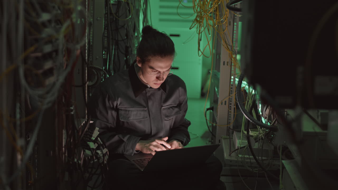 Technician Working in a Server Room