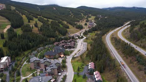 Drone-Shot-of-Copper-Ski-Resort,-Colorado-USA-in-Summer-Season,-Buildings,-Tracks-and-Traffic-on-Interstate-Highway