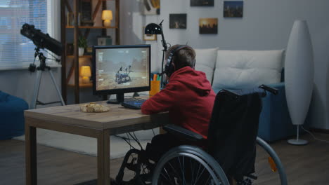 boy in wheelchair gaming on computer