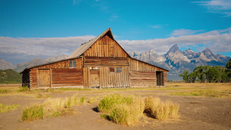 historic wooden barn with grand teton mountains landscape