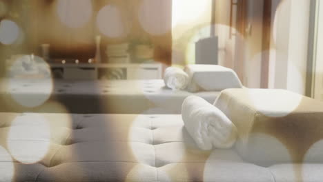 rolled towels on massage tables with bokeh lights animation in spa room