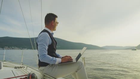 businessman working on a laptop on a yacht