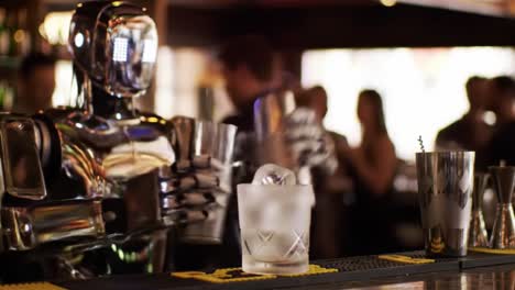 a robotic bartender skillfully shakes cocktails in a vibrant bar environment, showcasing advanced mixology technology and innovation in action