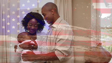 animation of flag of usa waving over happy african american parents with baby