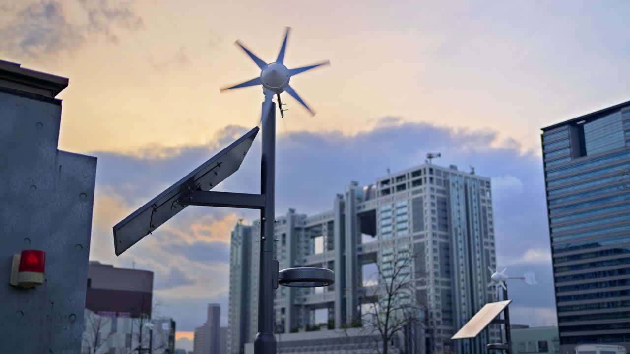 Close up of a small-scale renewable energy station with a wind turbine and a solar panel in Daiba, Tokyo, Japan