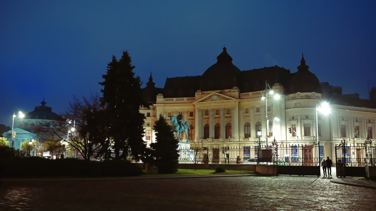 Bucharest, Romania - December 21, 2021: People walking in front of the Central University Library Carol I in the evening