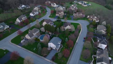 high aerial orbit around neighborhood at dusk