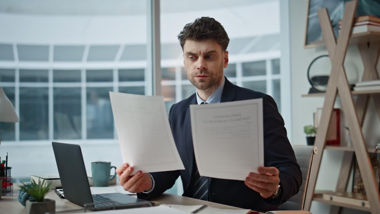 Frowned entrepreneur checking papers sitting desk closeup. Tensed businessman