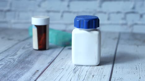 hand holding a white medicine bottle