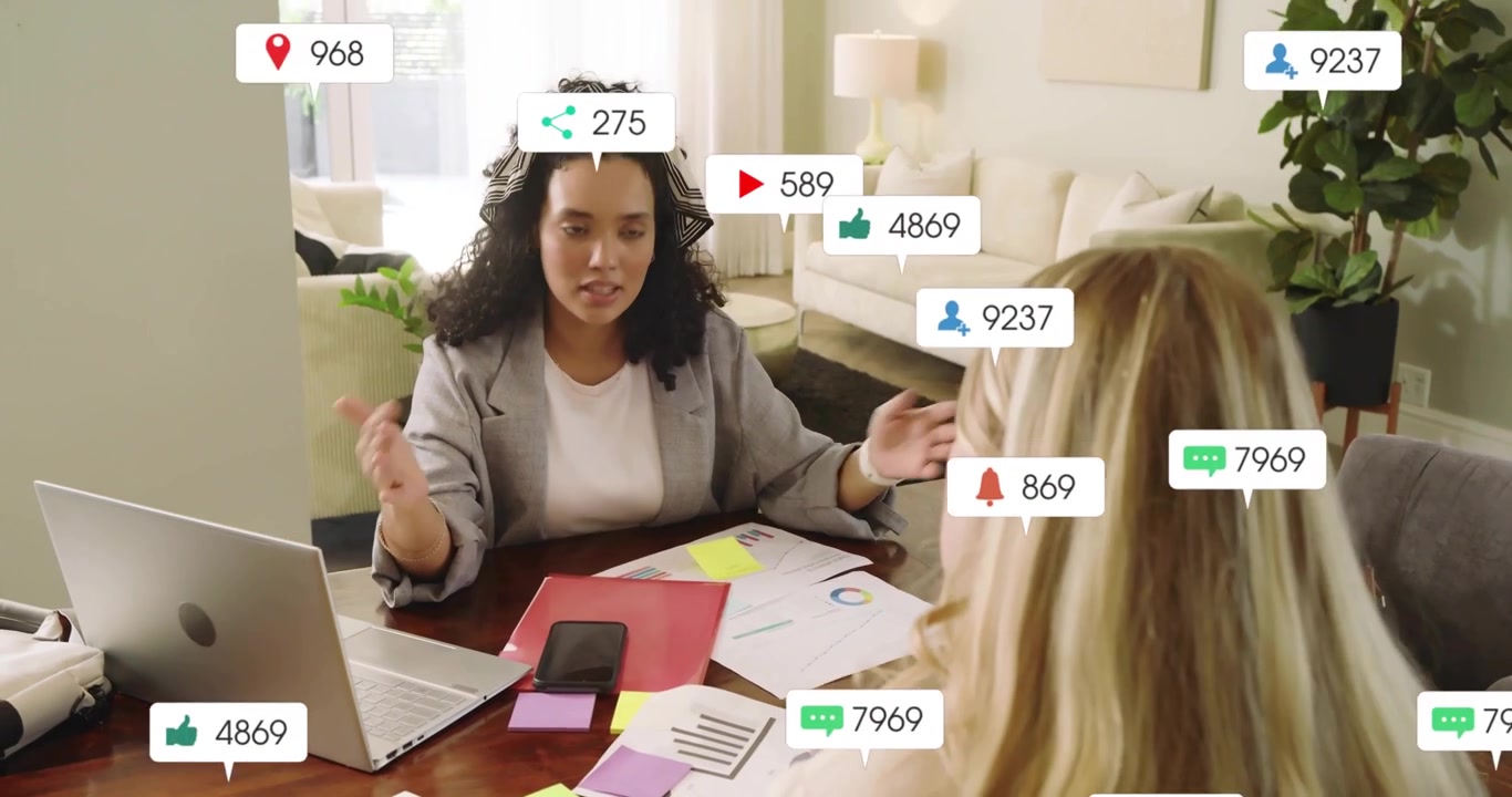 Lockiger Marketingexperte gestikuliert in Richtung Smartphone und erklärt schwebende Symbole, die das Zielgruppenwachstum zeigen