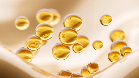golden oil or serum droplets on wavy cream background