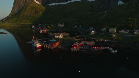 Reine-township-during-midnight-sunset,-aerial-orbit-view