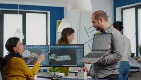 man project supervisor holding laptop and pointing on display