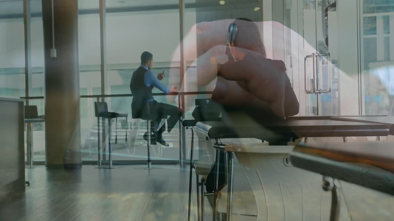 Animation of hand typing on computer over diverse business people in office