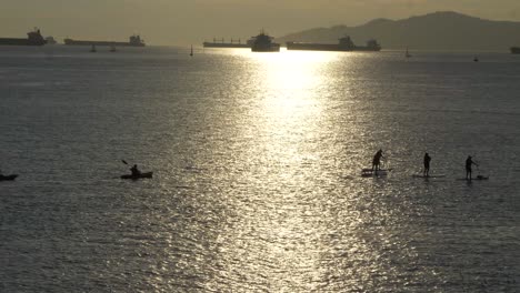 sunset group of paddle boarders at english bay vancouver