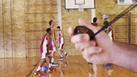 Close-up-of-trainer-holding-stopwatch