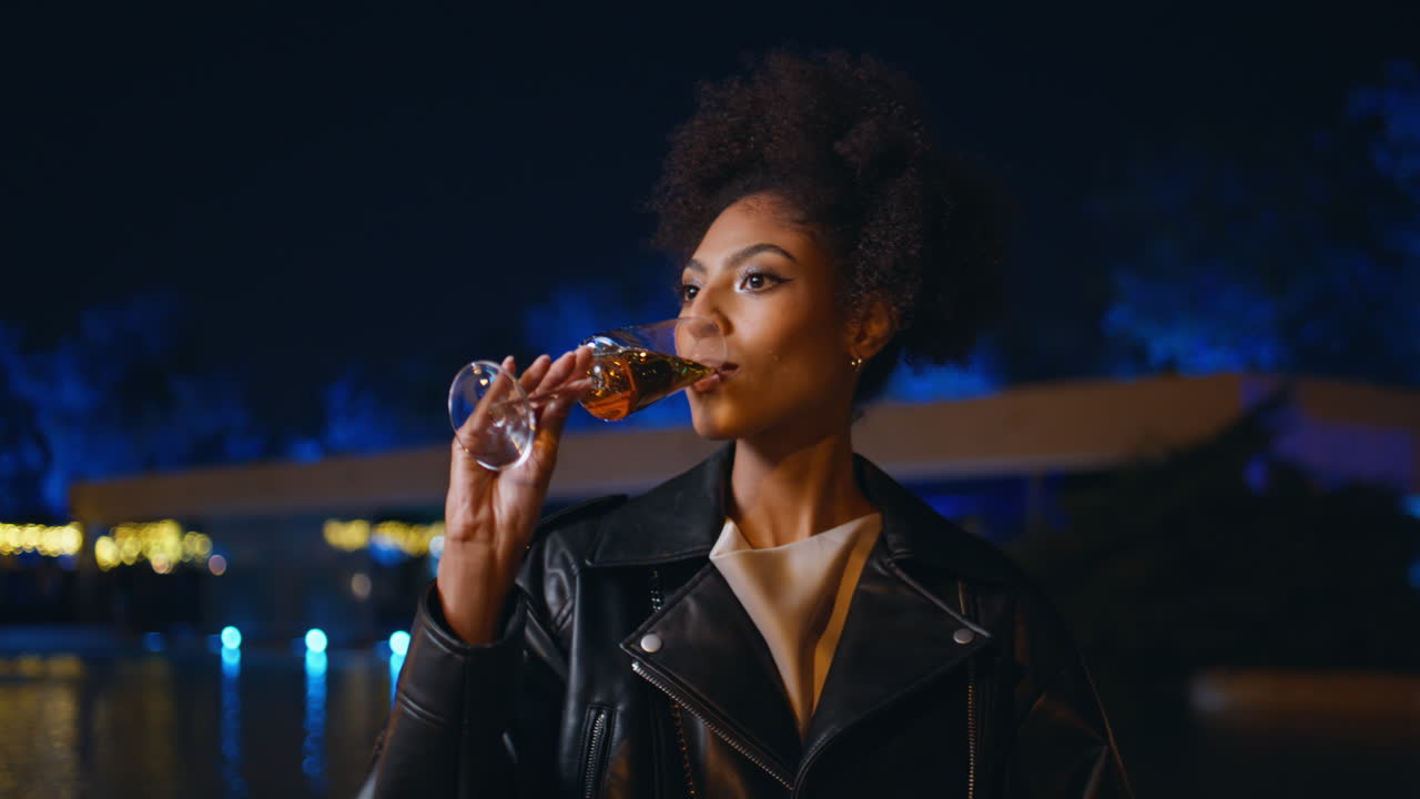 Woman enjoy night party outdoors drinking wine closeup. lady dancing