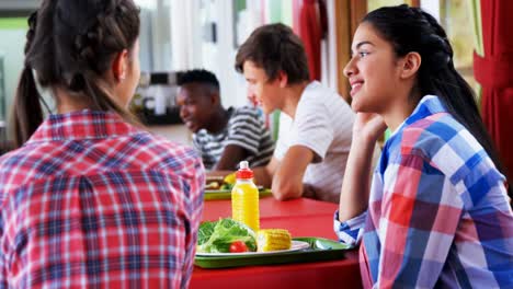 Schoolkids-interacting-with-each-other-while-having-meal-4k