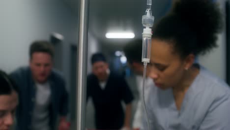 hospital corridor with medical personnel and iv