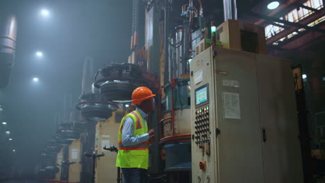 engineer looking modern machine at huge industrial professional facility.