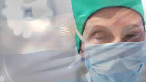 Animation-of-flag-of-argentina-waving-over-female-surgeon-in-operating-theatre