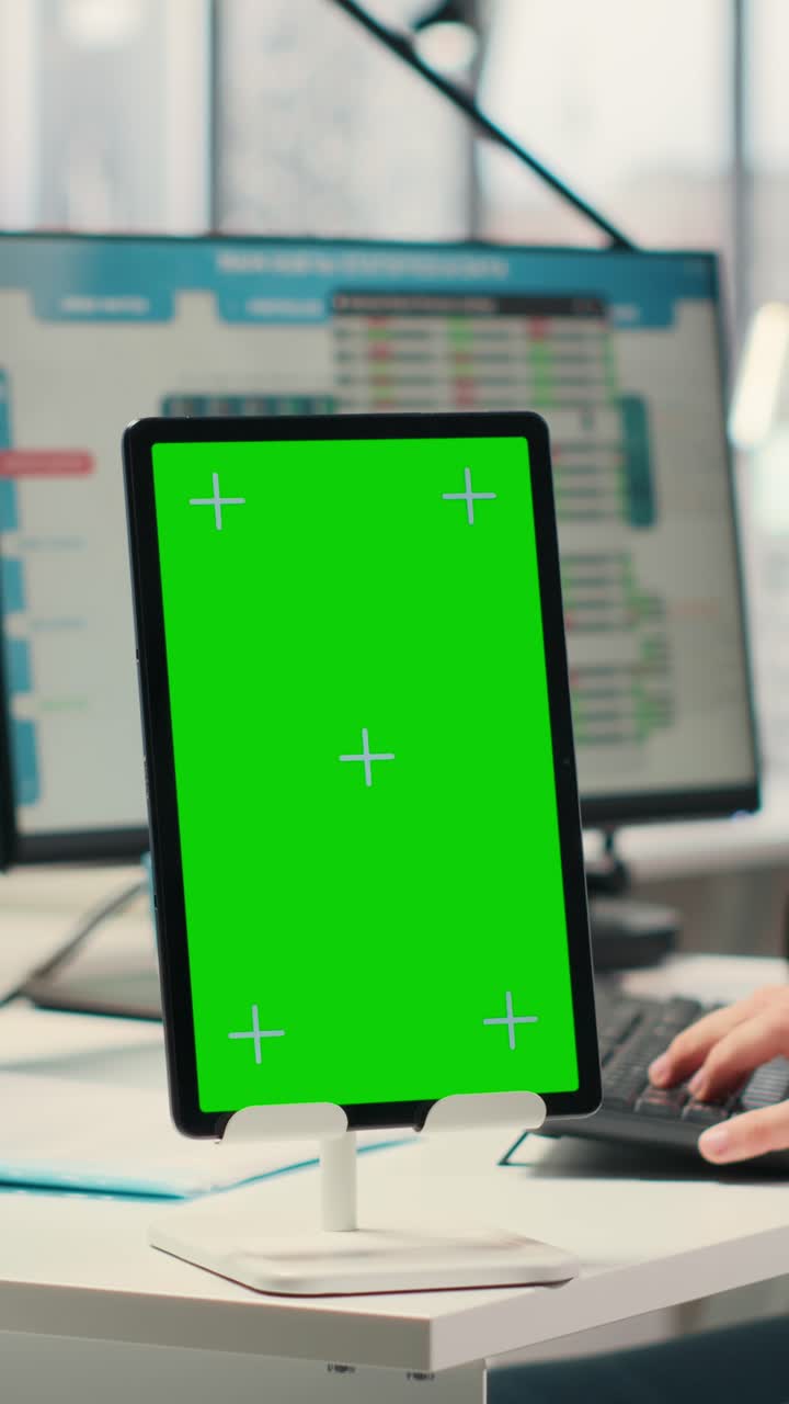 Vertical Video Business consultant examining forecasts with chroma key on tablet