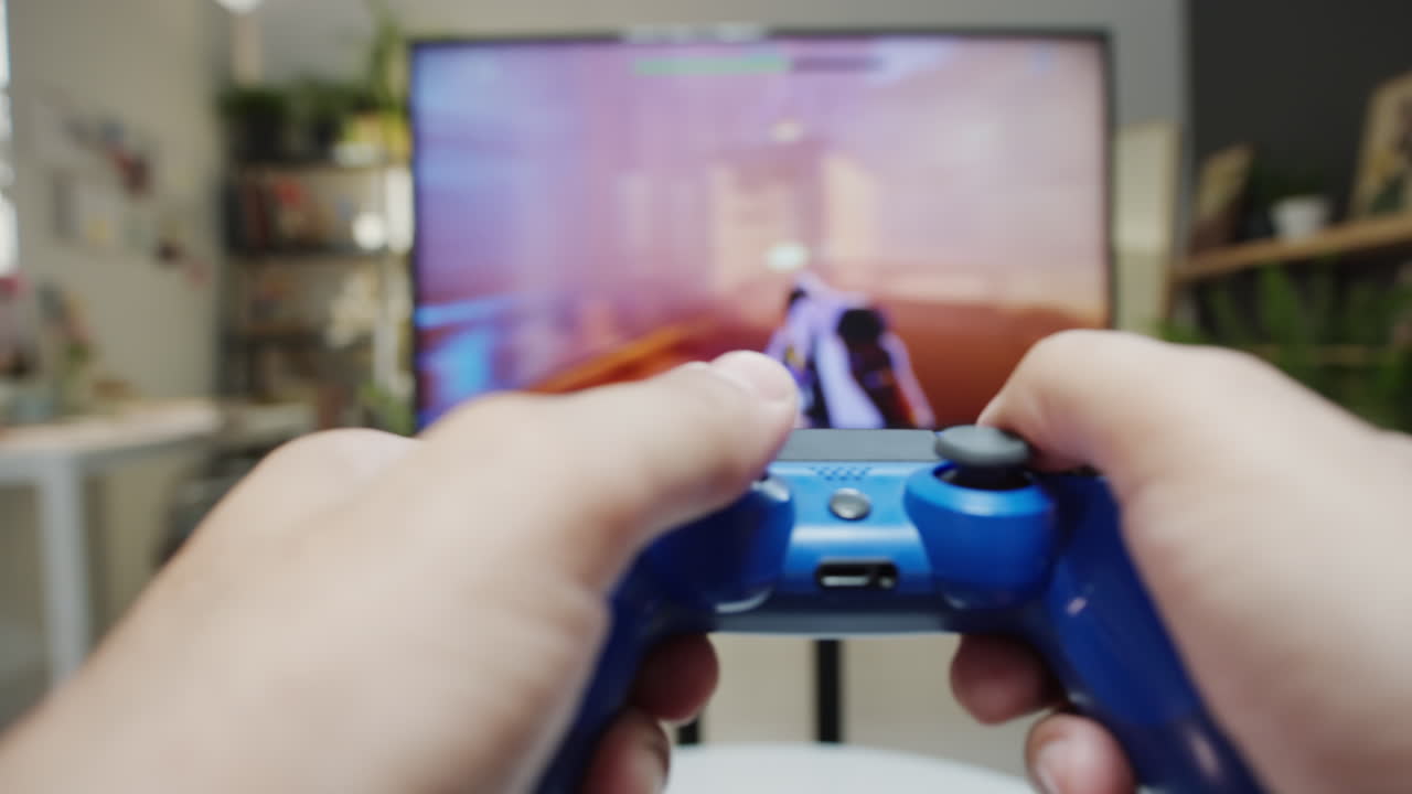 Close-up of hands playing video games with a controller