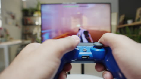 close-up of hands playing video games with a controller
