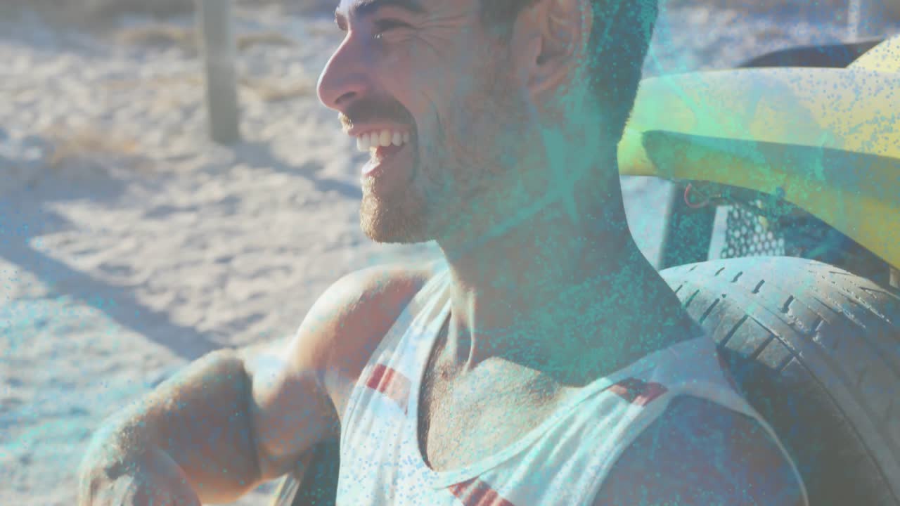 Man sitting on beach smiling calming camera widening showing boards teal overlay on face for travel