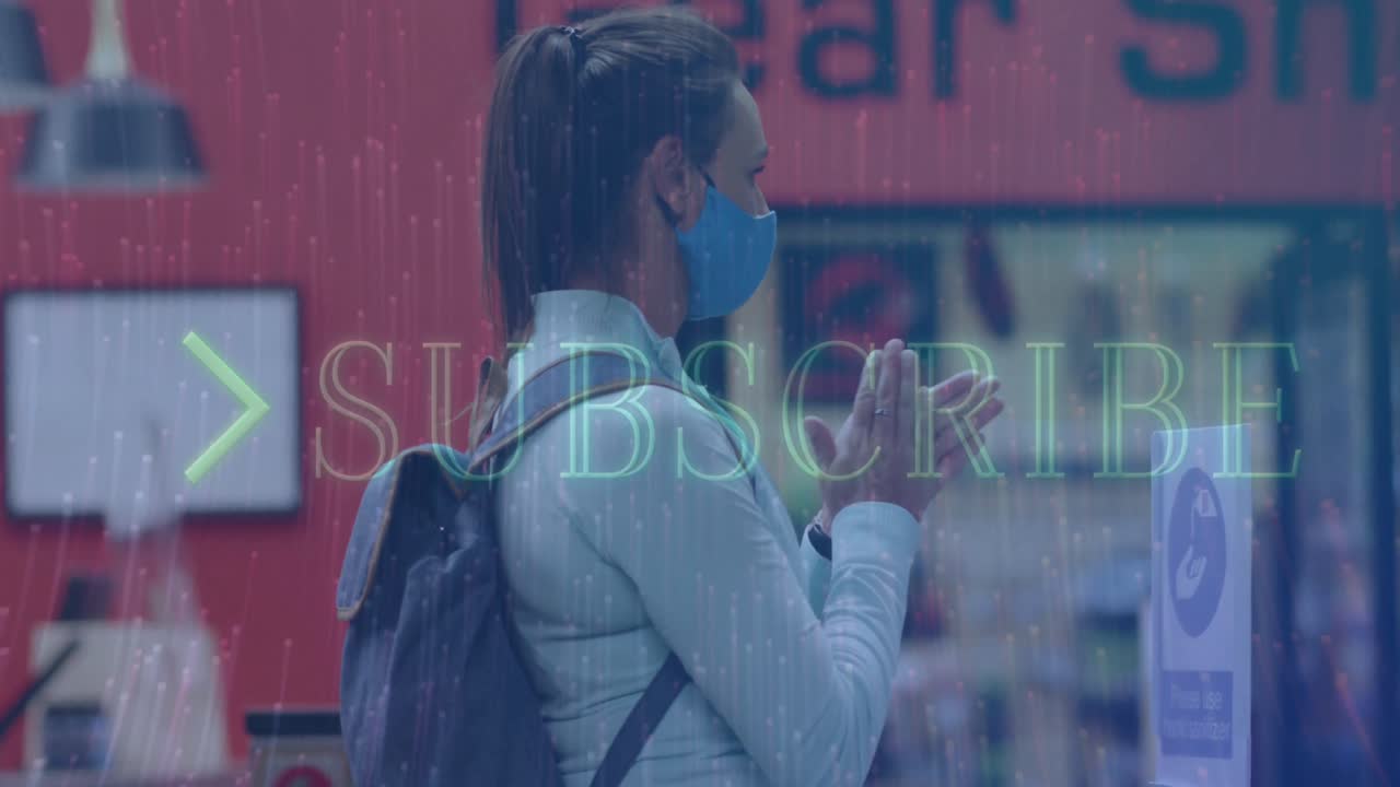 Animation of subscribe text over caucasian woman with face mask disinfecting hands