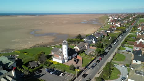 Converted-lighthouse,-Hoylake-Beachfront---aerial-drone-anti-clockwise-slow-rotate,-Wirral,-UK