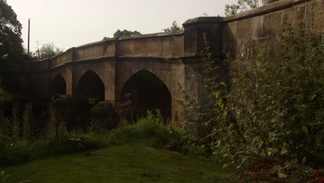 wide-shot-of-an-mediaeval-stone-bridge-in-the-village-of-Ilam