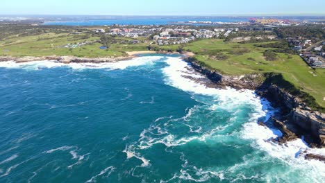 turquoise blue water of the beach and green meadow in little bay suburb in south-eastern sydney