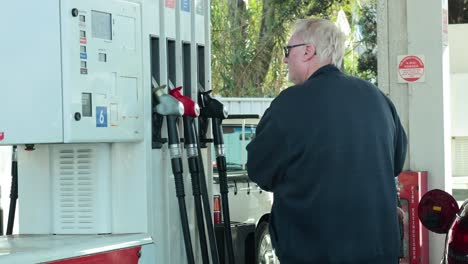 man refuels car at melbourne gas station