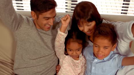 Smiling-Hispanic-family-put-their-hands-up