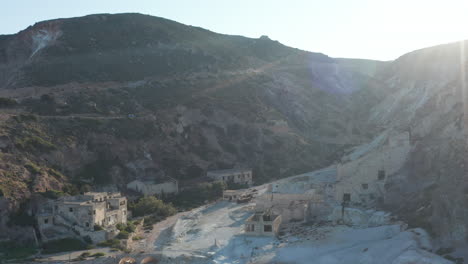 Wide-Aerial-Establishing-Shot-of-a-Tropical-Paradise-Bay-with-Turquoise-Water-on-Greek-Island-at-Sunset