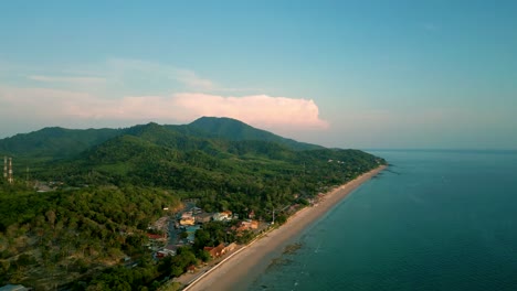 4K-Cinematic-nature-drone-footage-of-a-panoramic-aerial-view-of-the-beautiful-beaches-and-mountains-on-the-island-of-Koh-Lanta-in-Krabi,-South-Thailand,-during-sunset