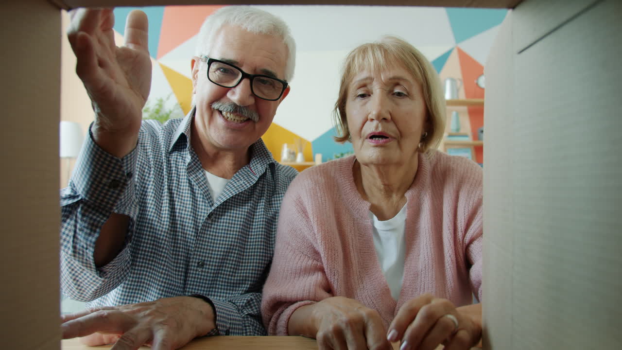Happy Elderly Couple Unpacking a Box