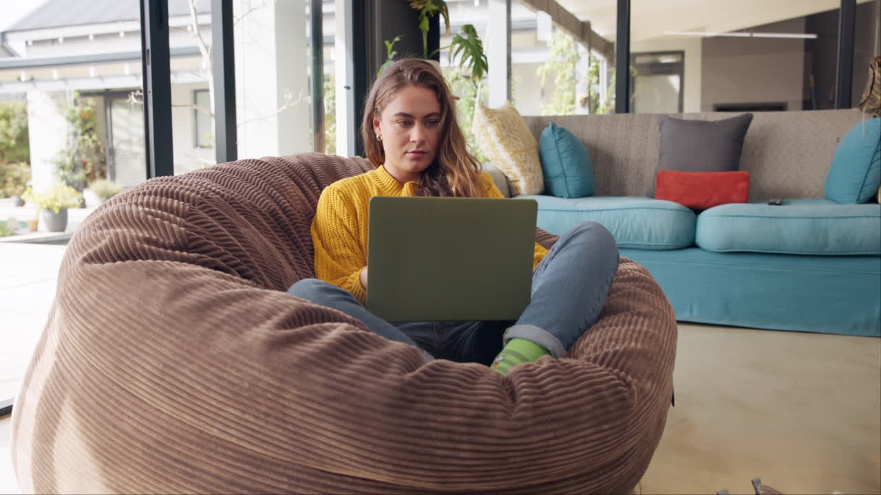 Woman working on laptop in living room