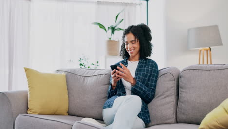 Woman,-smartphone-and-laughing-on-home-sofa
