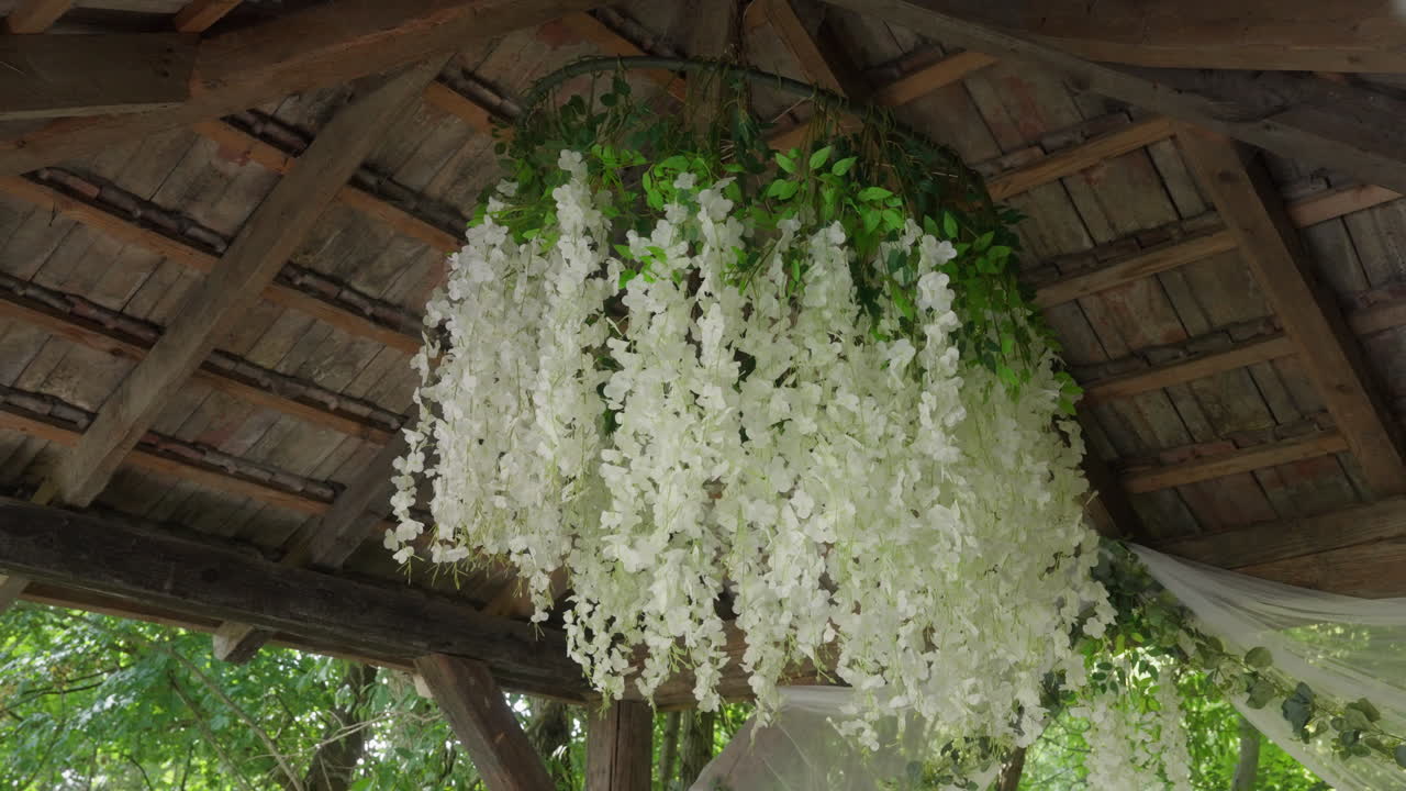 Rustic Wedding Gazebo Decorated with a Stunning White Wisteria Flower Chandelier