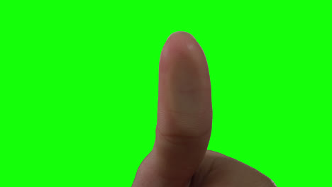 caucasian man pointing on green background